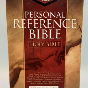 May include: A hardcover "Personal Reference Bible" in the King James Version. The cover is a mix of brown and red with the title in large, gold lettering. Features include center column references and words of Christ in red.