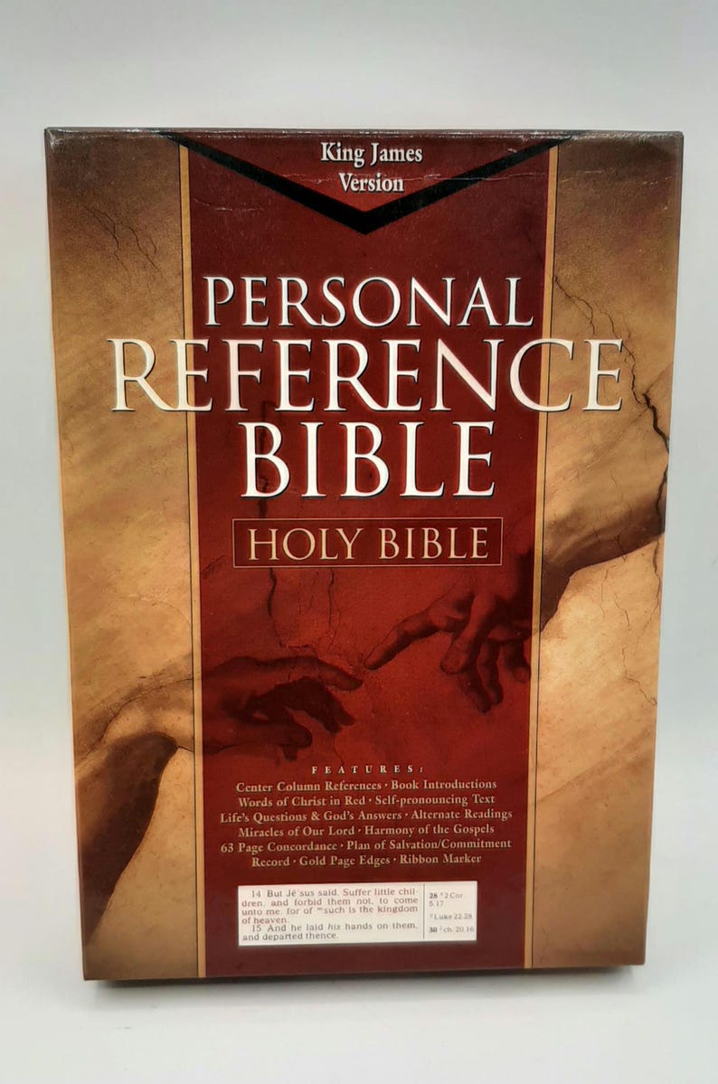 May include: A hardcover "Personal Reference Bible" in the King James Version. The cover is a mix of brown and red with the title in large, gold lettering. Features include center column references and words of Christ in red.