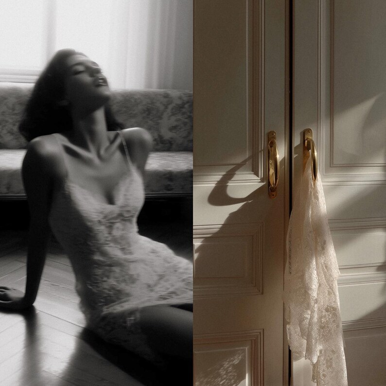 May include: A black and white image of a woman wearing a white lace slip dress, sitting on a wooden floor. The dress has spaghetti straps and a delicate floral pattern. A white lace garment hangs on a door with gold handles.