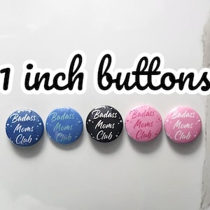 May include: Five 1 inch round buttons with the text "Badass Moms Club" in white lettering on a blue, teal, black, pink, and light pink background.