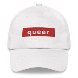 May include: White baseball cap with a red box that says "queer" in white letters.