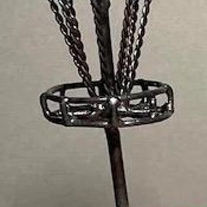 May include: A miniature black metal disc golf basket with a chain basket and a pole.