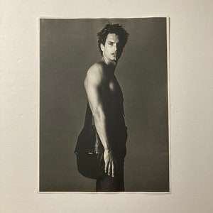 MARCUS SCHENKENBERG -  Fashion portrait of the model with a leather shoulder bag. 13 inch by 10 inch photograph.