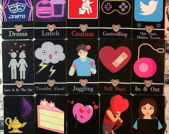 May include: A set of 16 black cards with colorful illustrations and text. The cards feature various themes, including love, relationships, and life events. The cards are designed with a coffee cup icon in the bottom corner.
