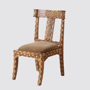 May include: A wooden chair with intricate inlaid floral patterns and a brown upholstered seat. The chair has a simple, elegant design with a high back and curved legs.