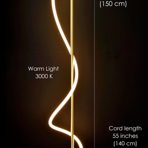 May include: A gold floor lamp with a curved, white light source. The lamp has a wooden base and a cord length of 55 inches (140 cm). The lamp is 60 inches (150 cm) tall. The light is warm white, 3000K.