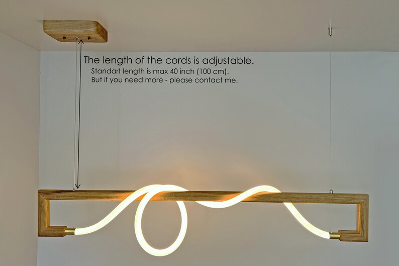 May include: A wooden light fitting with a white LED light that is shaped like a wave. The light is suspended from the ceiling by a cord that is adjustable up to 40 inches (100 cm).