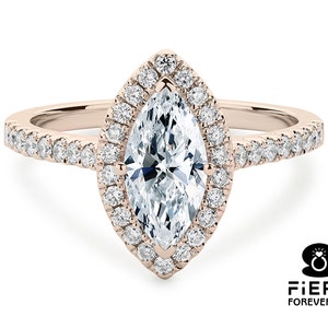 May include: A rose gold engagement ring with a marquise-shaped diamond center stone surrounded by a halo of smaller diamonds. The band is also set with smaller diamonds.