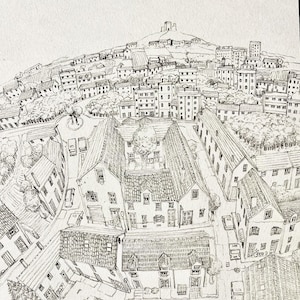 May include: A detailed pen and ink drawing of a European townscape. The artwork depicts buildings, streets, and a hilltop castle. The perspective is from above, showcasing the town's layout and architectural details. The drawing is in black and white.