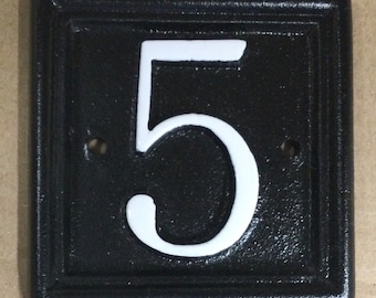 Small solid cast iron house sign displaying the number 5 only