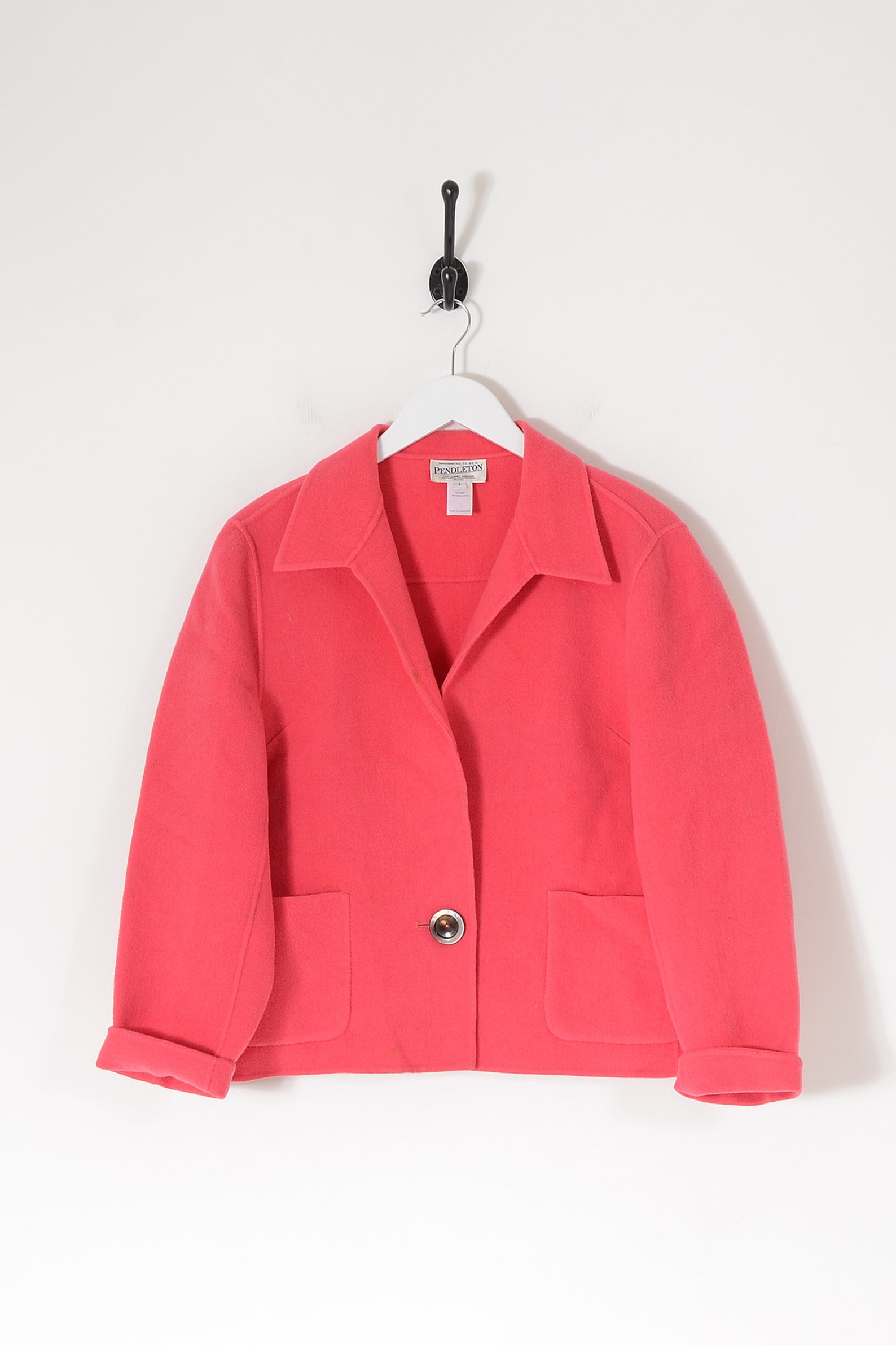 Vintage Pink wool cropped Pendleton blazer jacket in bright pink with single centre button fastening. It has two patch pockets, full length sleeves with a rolled cuff and a shirt style collar. Tag states size large.