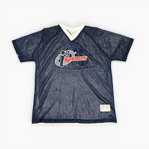 May include: Navy blue mesh jersey with a white V-neck collar and hem. The jersey features the logo "i9 SPORTS" in red and grey on the front. A tag on the lower right corner indicates the size is "XL".