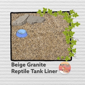May include: Beige granite reptile tank liner with a blue food bowl and two gray rocks. The liner is surrounded by green ivy.
