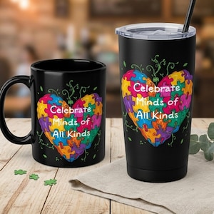 May include: Black mug and tumbler set featuring a colorful puzzle heart design with the text "Celebrate Minds of All Kinds." The heart is composed of various colors, including yellow, purple, green, and blue. The tumbler includes a black straw and lid.