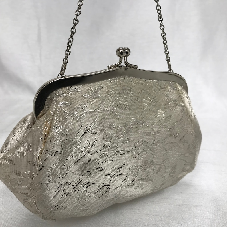 White and silver vintage handbag