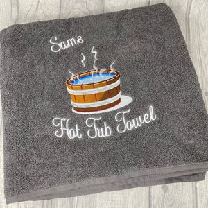 May include: Gray bath towel with white embroidery that says "Sam's Hot Tub Towel" and a cartoon image of a hot tub with steam rising from it.