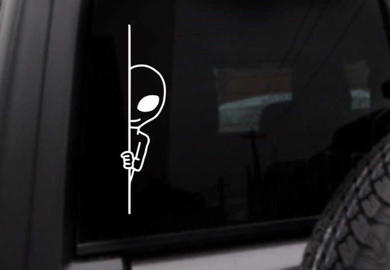 May include: A white outline of an alien peeking around a corner. The alien has large eyes and a small mouth.