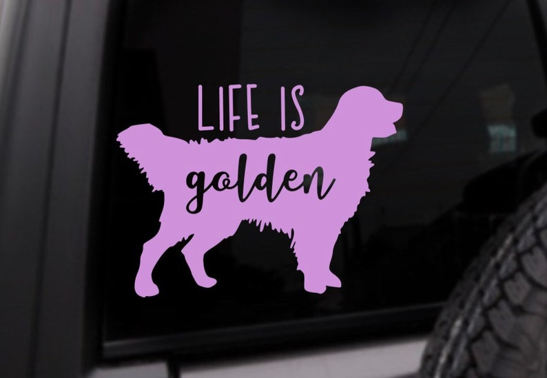 May include: A purple vinyl decal with the silhouette of a golden retriever and the text "Life is golden".