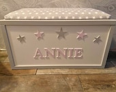 Personalised toy box with safety gas strut.