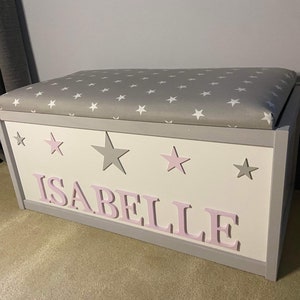 Large personalised toy box with safety gas strut. Hinged lid with padded seat, ideal nursery furniture/ baby gift. Personalised blanket box.