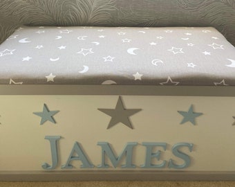 Personalised toy box with safety gas strut.