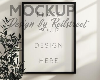 Vertical Black Frame With Plant Mockup PSD in Warm Home Interior