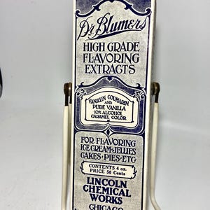 May include: A vintage box of Dr. Blumers High Grade Flavoring Extracts. The box is white with blue lettering and a decorative border. It says "Vanillin Coumarin and Pure Vanilla 10% Alcohol Caramel Color" and "For Flavoring Ice Cream Jellies Cakes Pies Etc". The box also says "Contents 4 oz. Price 50 Cents" and "Lincoln Chemical Works Chicago The House of Quality".