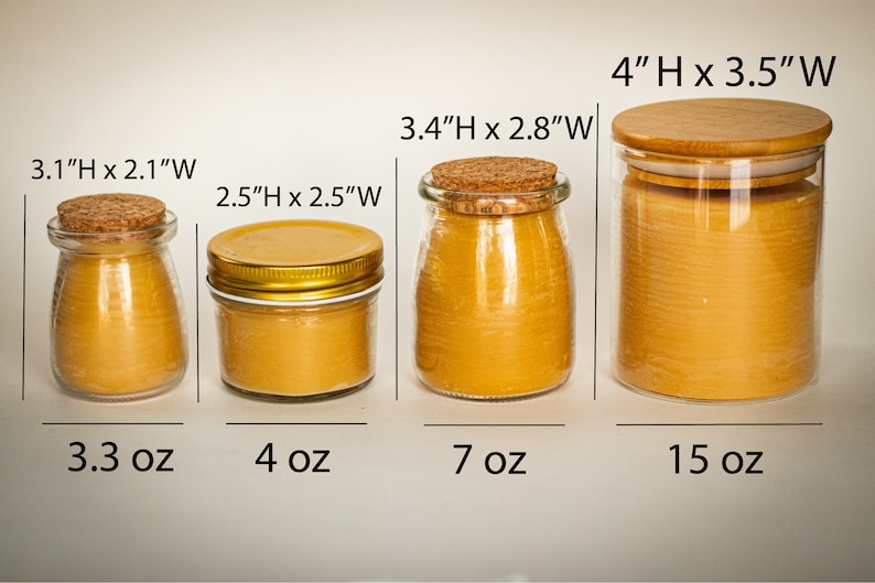 May include: Four glass candle jars with different sizes and lids. The jars are filled with a yellow candle wax. The jars are labelled with their size in inches and ounces. The sizes are 3.1 inches by 2.1 inches, 2.5 inches by 2.5 inches, 3.4 inches by 2.8 inches, and 4 inches by 3.5 inches. The ounces are 3.3 ounces, 4 ounces, 7 ounces, and 15 ounces.