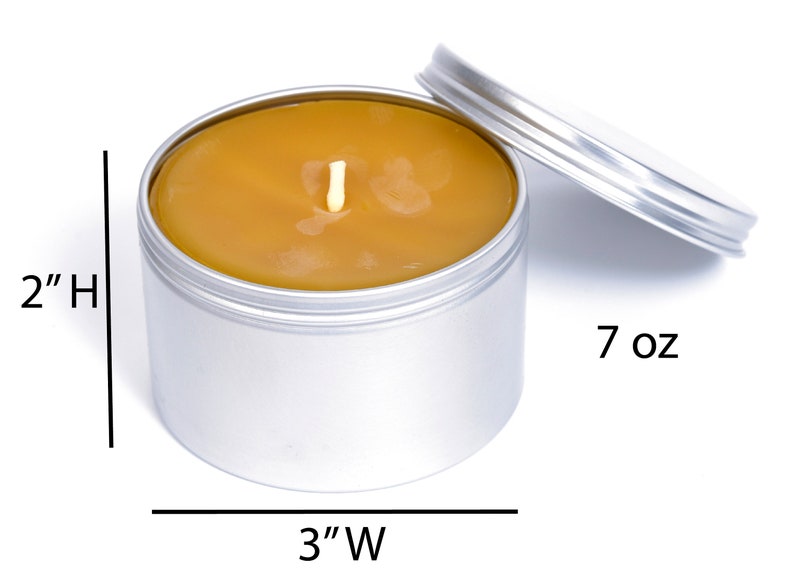 May include: A 7 ounce, silver tin candle with a yellow wax top and a single wick. The candle is 2 inches tall and 3 inches wide.