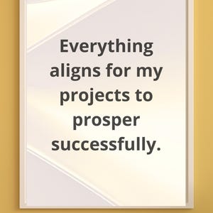 Puede incluir: Impresión enmarcada en blanco con el texto "Everything aligns for my projects to prosper successfully". La impresión tiene un diseño abstracto blanco y beige claro sobre un fondo amarillo.