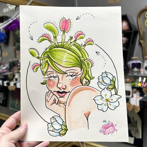 May include: A hand-drawn illustration of a woman with a head of Venus flytraps. She has a pink bar of soap with the word "Soapy" on it. The illustration is done in a cartoon style with bright colours.