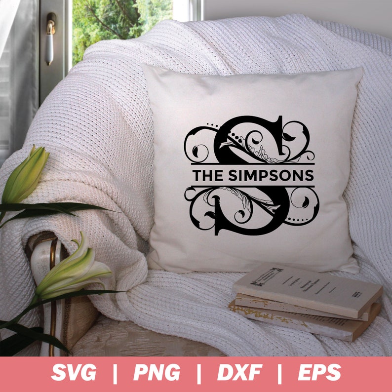 May include: White throw pillow with a black monogram of the letter "S" with decorative flourishes. The text "THE SIMPSONS" is printed on a black banner below the letter.