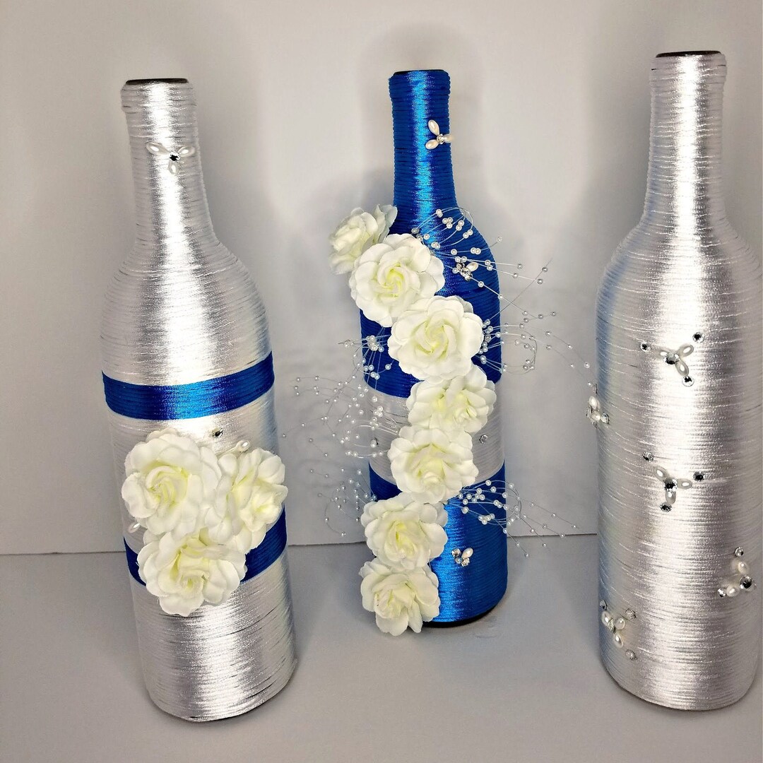 Blue and White Wrapped Wine Bottle Set With White Silk Flowers for a