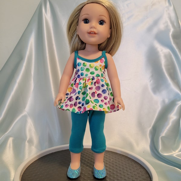 Two-piece outfit has watercolor bubble print top, teal trim and capris and fits Wellie Wishers, Glitter Girls and other 14-15 inch dolls.