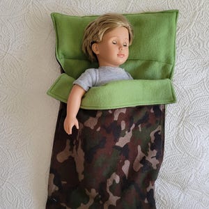 Sleeping bag has camo flannel outer shell and green fleece lining, built-in pillow & fits  like American Girl , OG and other 18 inch dolls.