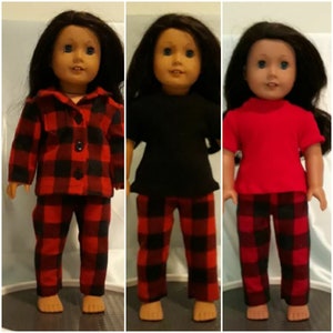 May include: Three dolls wearing different outfits with red and black plaid pants. The doll on the left is wearing a red and black plaid shirt. The doll in the middle is wearing a black shirt. The doll on the right is wearing a red shirt.