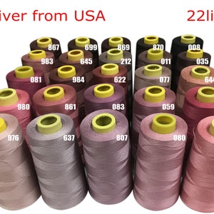 May include: Twenty-two spools of thread in various shades of pink, red, and brown. The spools are arranged in a semi-circle and have yellow tops. The text "Deliver from USA" and "22lines" is visible at the top of the image.