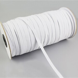 May include: A spool of white elastic cord, perfect for sewing projects or crafting.