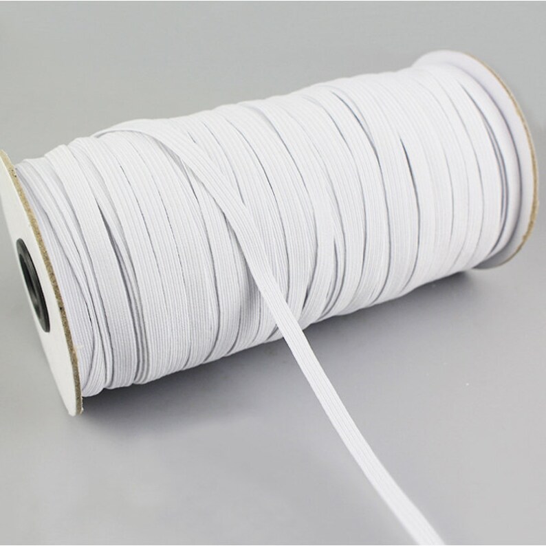 May include: A spool of white elastic cord, perfect for sewing projects or crafting.