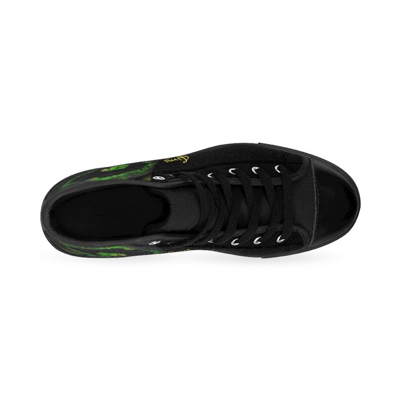 May include: Black high-top canvas sneakers with a green and yellow floral print. The shoes have white laces and a black rubber sole.