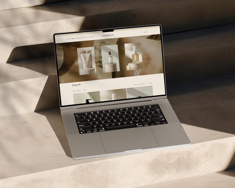 May include: A laptop computer open to a website with the text "Shop All" and images of various products. The website is for a company called "Remarkable".