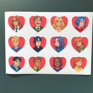 May include: Sheet of stickers featuring cartoon portraits of various characters inside red heart shapes. The characters have different hair colors and styles, and wear a variety of clothing. The stickers are on a white background.