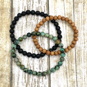 May include: Three beaded bracelets, one black, one brown, and one turquoise.