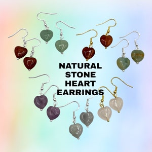May include: Assortment of natural stone heart earrings in various colors, including green, red, purple, and pink. The earrings are displayed on a light blue background with the text "NATURAL STONE HEART EARRINGS".