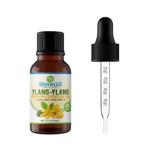May include: A brown glass bottle of Ylang-Ylang essential oil with a black cap and a white label. A clear glass dropper with a black top is next to the bottle. The label reads "Grimweed Apothecary Ylang-Ylang Premium Essential Oil".