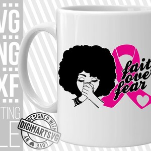 May include: White ceramic mug with a pink ribbon and the text "faith over fear". A black silhouette of a woman with an afro hairstyle is praying with her hands clasped together.