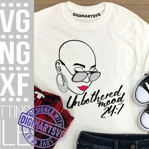 May include: White t-shirt with a black and white illustration of a woman with a bald head wearing sunglasses. The text "Unbothered mood 24:7" is printed in black below the illustration.