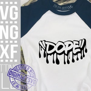 May include: A white t-shirt with a black graphic of the word "DOPE" in a dripping graffiti style. The shirt has a navy blue raglan sleeve.