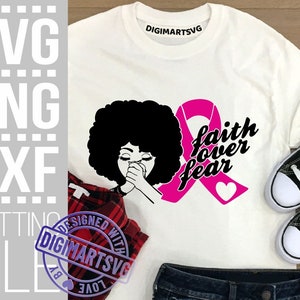 May include: White t-shirt with a pink ribbon, a black silhouette of a woman with her hands clasped in prayer, and the text "faith over fear".