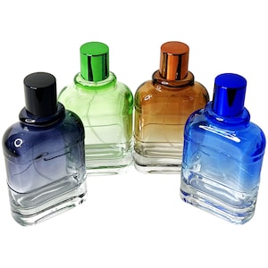 May include: Four glass perfume bottles with colorful gradients. The bottles have a square shape with rounded edges and matching colored caps. The colors include blue, green, brown, and black. The bottles are on a white background.